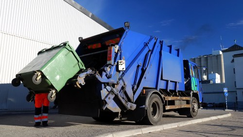 Construction site with waste being cleared by professionals