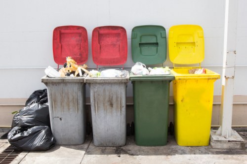 Team handling commercial waste bins at a business site